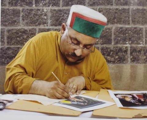 Dr Vijay Sharma, a senior artist at the Bhuri Singh Museum, Chamba, working on a miniature painting (Courtesy: Dr Vijay Sharma)