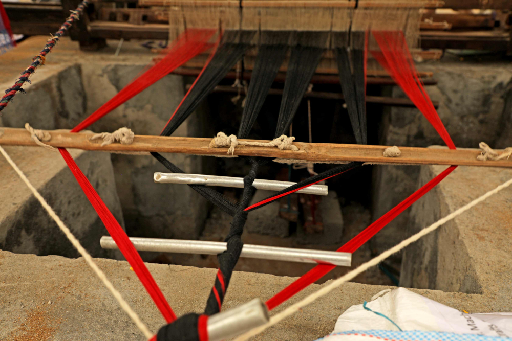 the yarn hank gets knotted to a pole from which the yarns are connected through the head shafts to the cloth roll at the weaver’s end. 