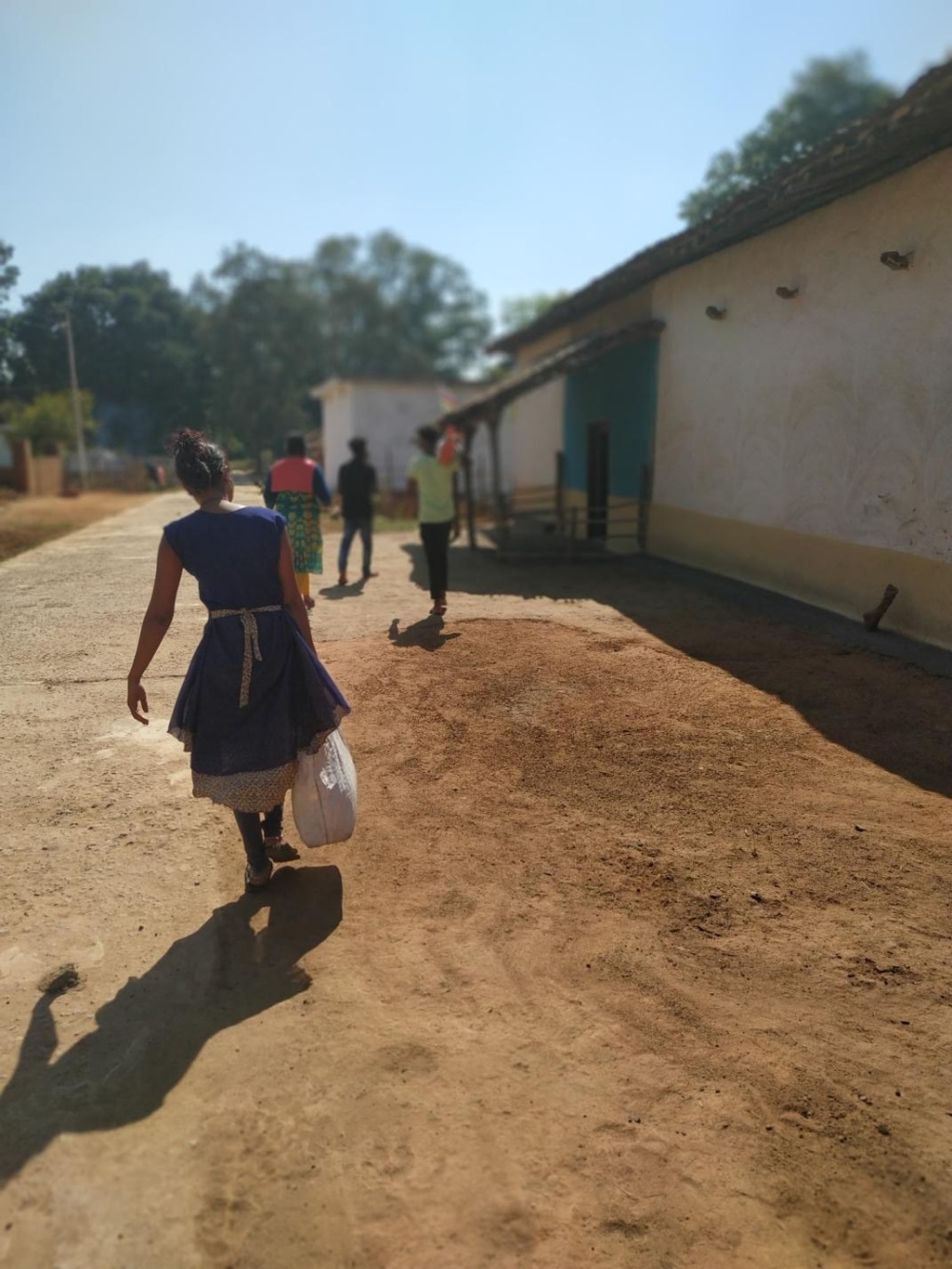 Group of young men and women with their share of offering.