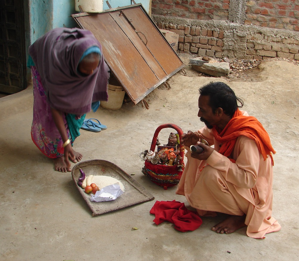 Ram Prasad Vasudeva receiving offering from a woman