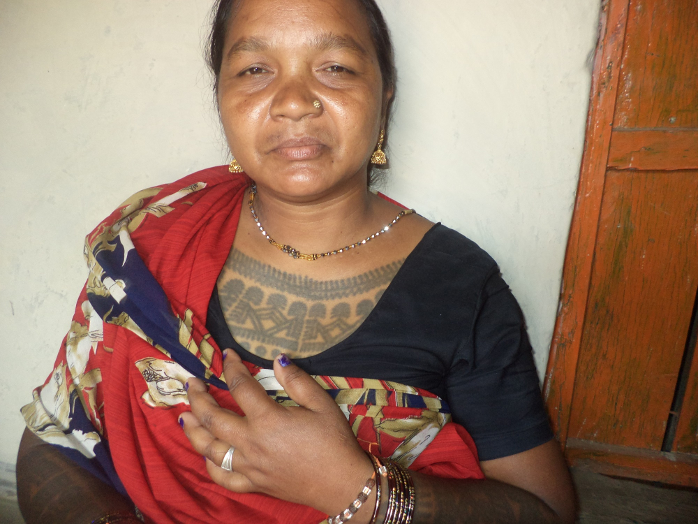 A woman with godna on her chest