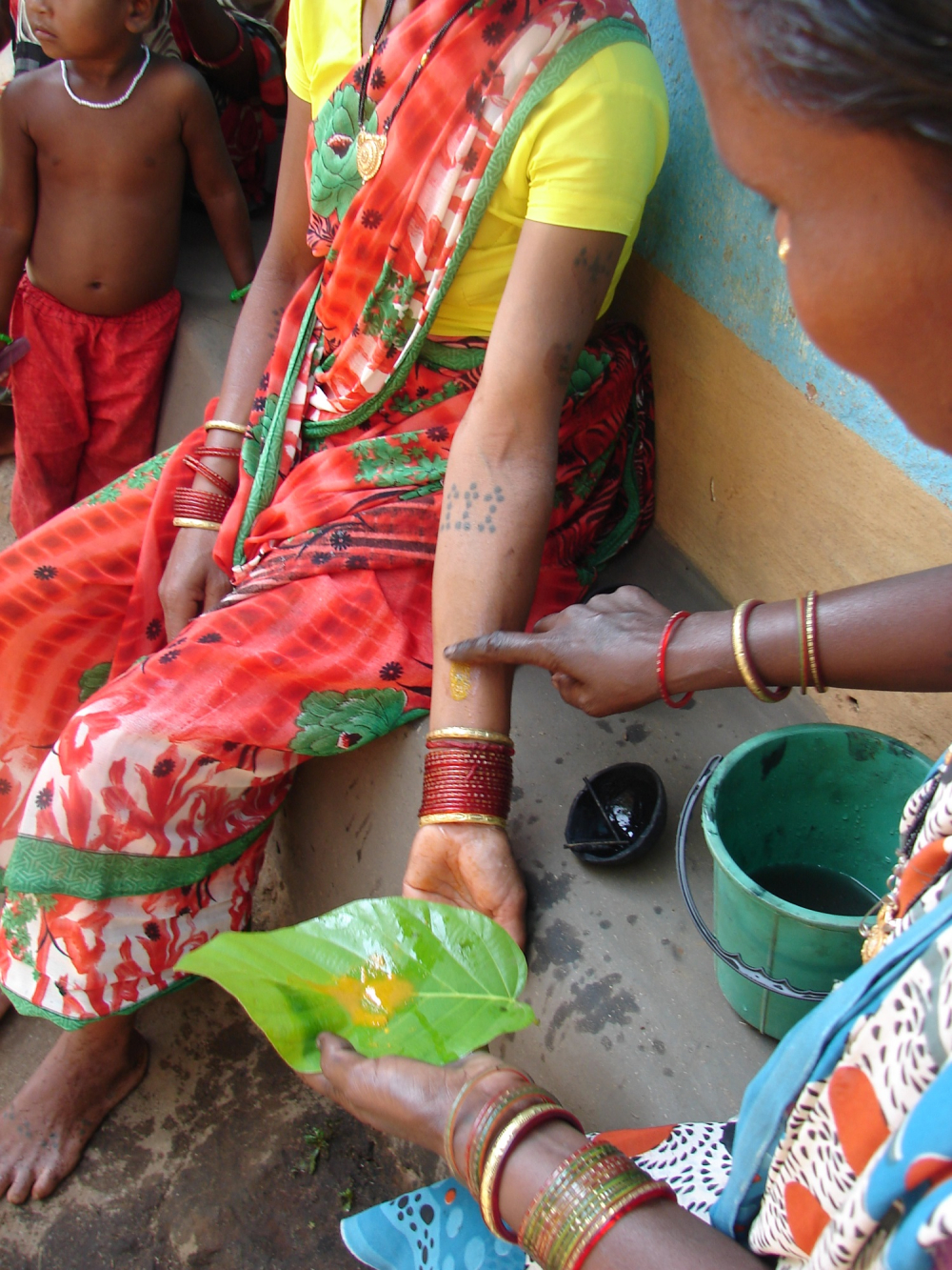 Turmeric paste is applied to the newly etched godna 