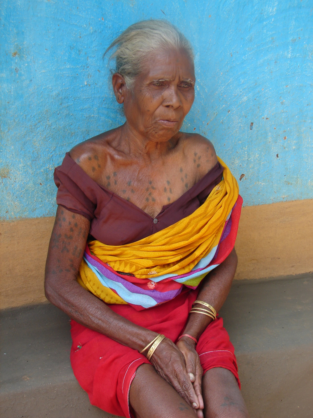 A woman with godna on her chest and hands
