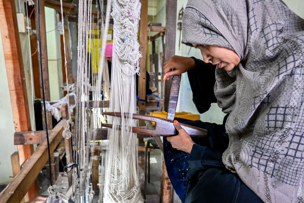 Weaver sits at a pit loom. (Picture Credits: Anil Purohit)