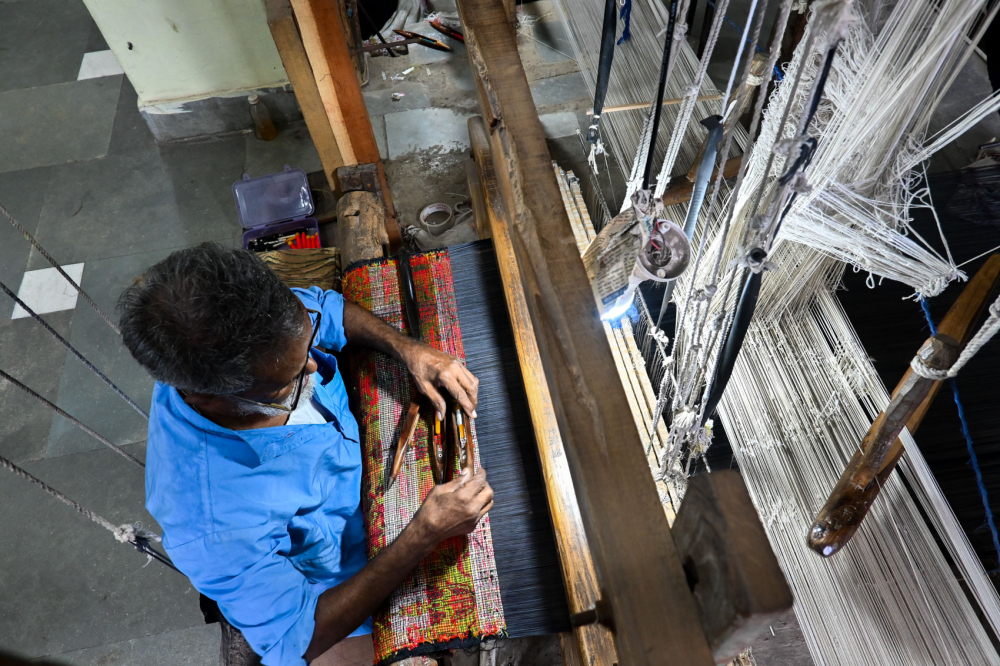 Weaver working the loom. (Picture Credits: Anil Purohit)