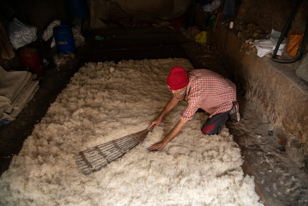 A craftsman prepares wool for traditional namda felting.