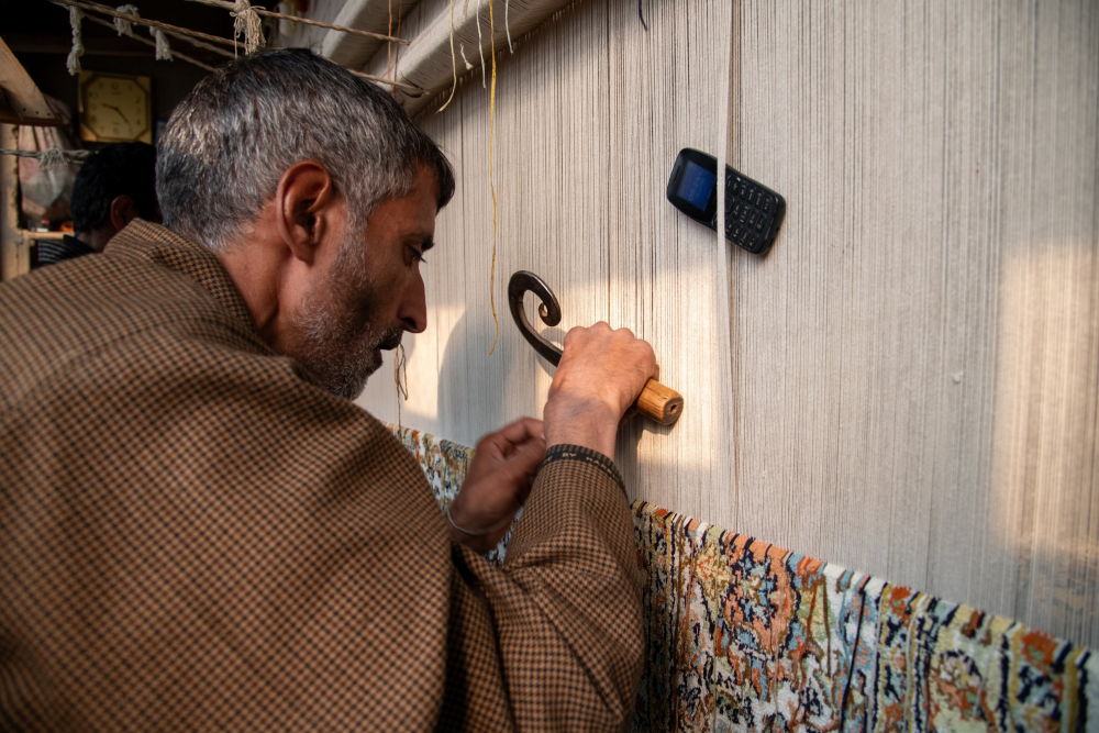 A weaver meticulously knots a kalbaff, preserving a centuries-old Kashmiri tradition. (Picture Credits: Syed Muneeb Masoodi)