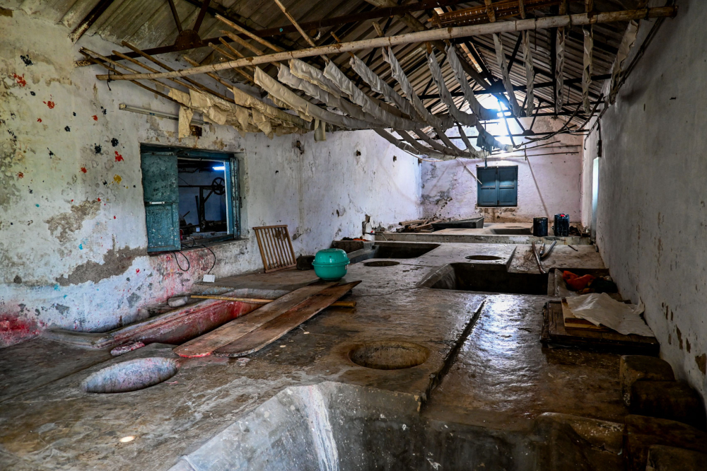 Interior of the paper mill, featuring pits used for processing raw materials and areas where paper is laid out to dry after pressing. (Picture Credits: Anil Purohit)