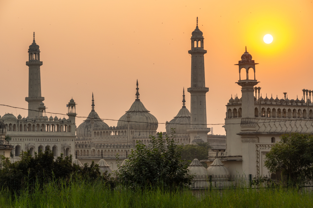 View of Asafi Mosque featuring three domes, two minarets, chhatris and ornate stucco work with floral motifs. (Picture Credits: Monis Khan)