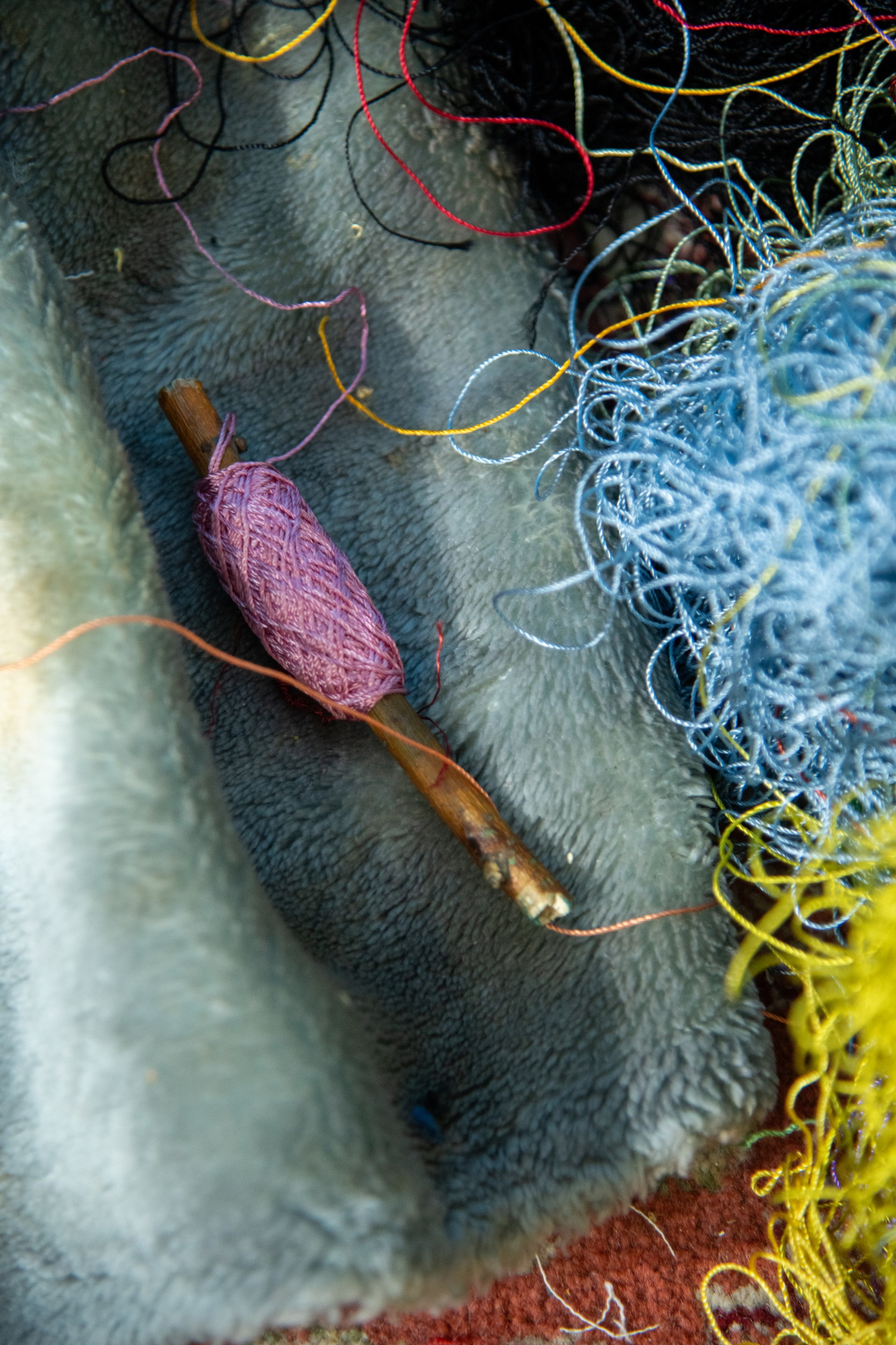 Threads are meticulously rolled and sorted, ready to be transformed into intricate aari embroidery. 