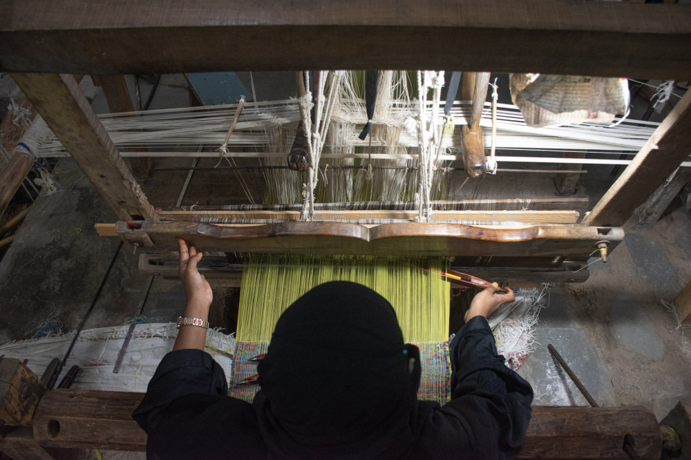 Weaver sits at a pit loom. (Picture Credits: Anil Purohit)