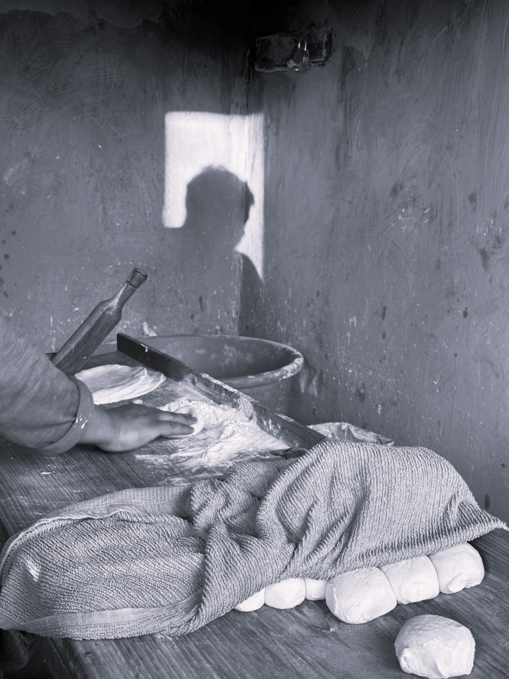 Flattening the dough balls for baking. (Picture Credits: Taha Mughal)