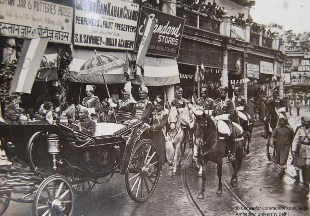 Fig 1: Dr. Rajendra Prasad in the presidential coach, Chandni Chowk, 1950. While the image focuses on the parade, it simultaneously documents the shop signages on the street (Courtesy: Narain Prasad, from the CCK Archives, Ambedkar University Delhi)