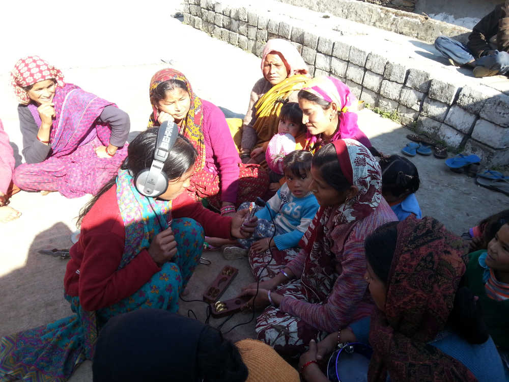 Fig. 3. Rameshwari Devi, who was part of a training programme organised by People’s Power Collective with Mandakini ki Awaaz, records performers from the Mahila Mangal Dal in Basti as they introduce themselves before singing. Community radio stations in India support and encourage local talent and art forms in ways that allow for artistes to reach out to larger, engaged audiences. It also facilitates the continuity of several local cultural traditions which may not find support elsewhere (Photograph by Shweta Radhakrishnan/ Courtesy: People’s Power Collective)