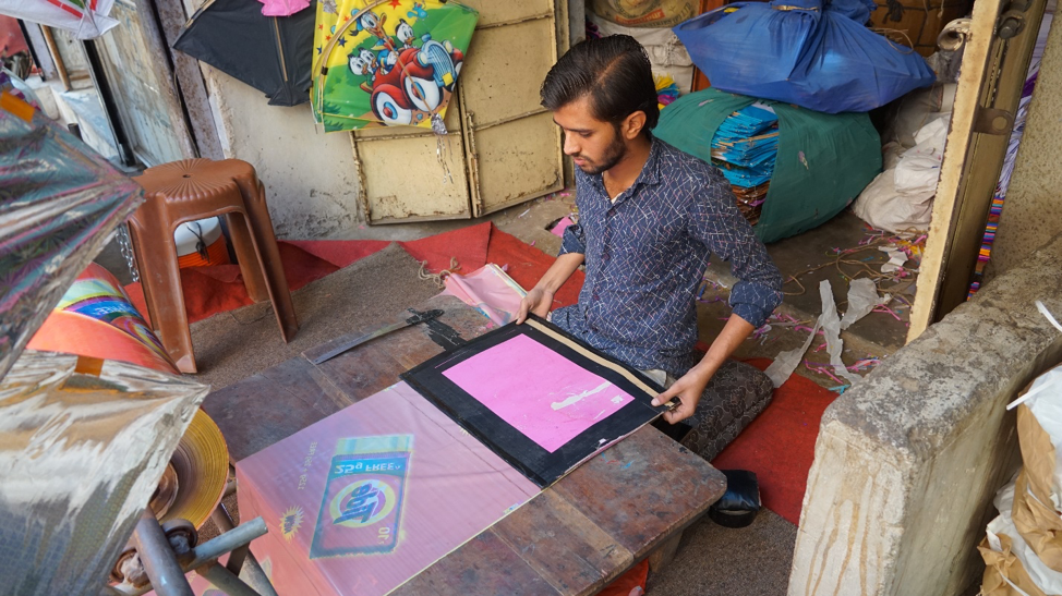 Fig. 1: Cutting paper with a stencil to ensure uniform shape. (Courtesy: Ashna Patel)