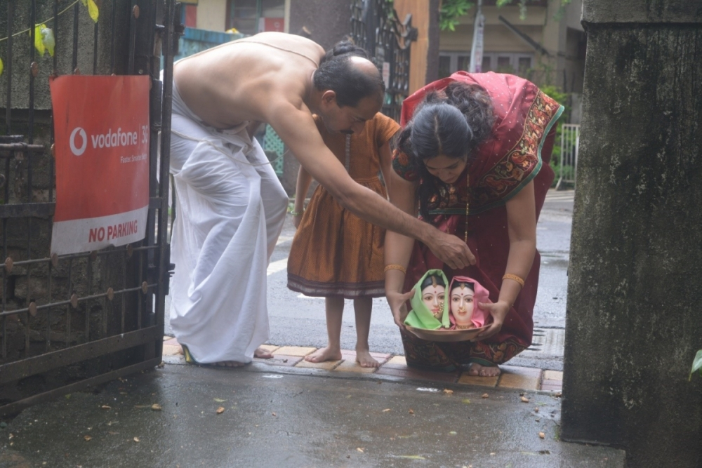 Fig. 3: Invocation of the goddessess first by the process of keeping fabric on the head facemaks and are taken out of the home by married women in the home.