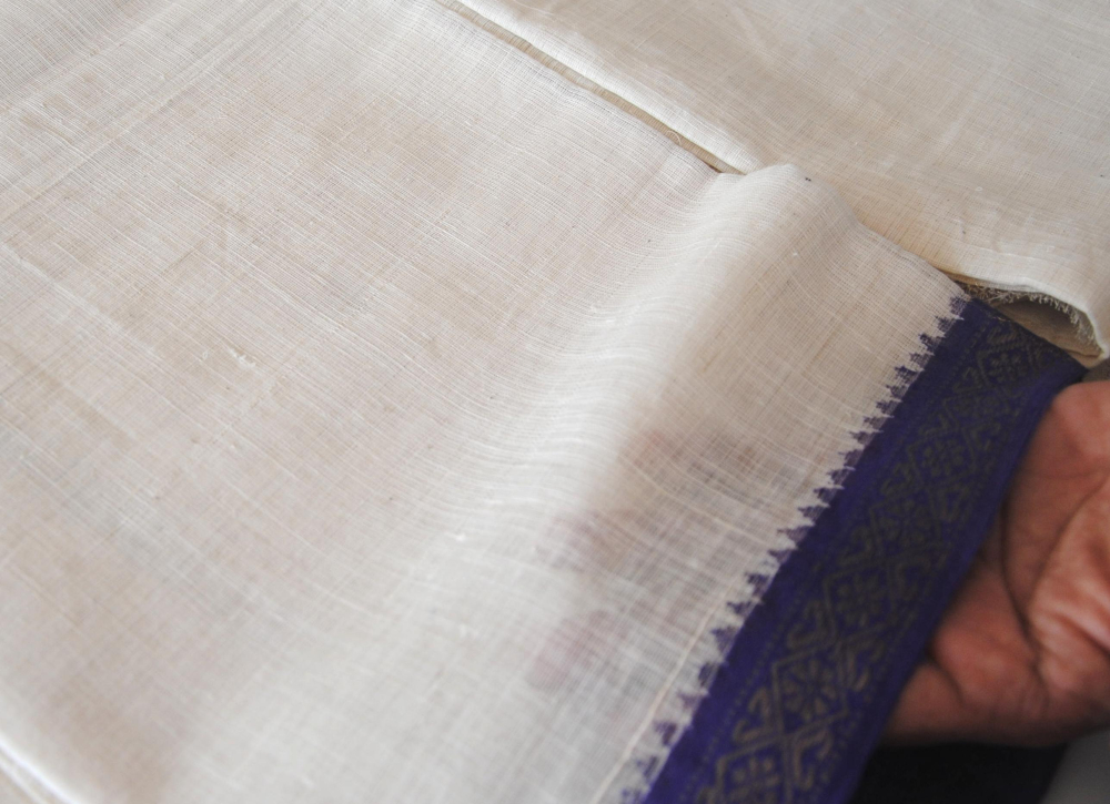 A 100s count patnulu dhoti at the khadi retail outlet with a temple border. Note the texture and fineness of the fabric (Courtesy: Samyuktha Gorrepati)