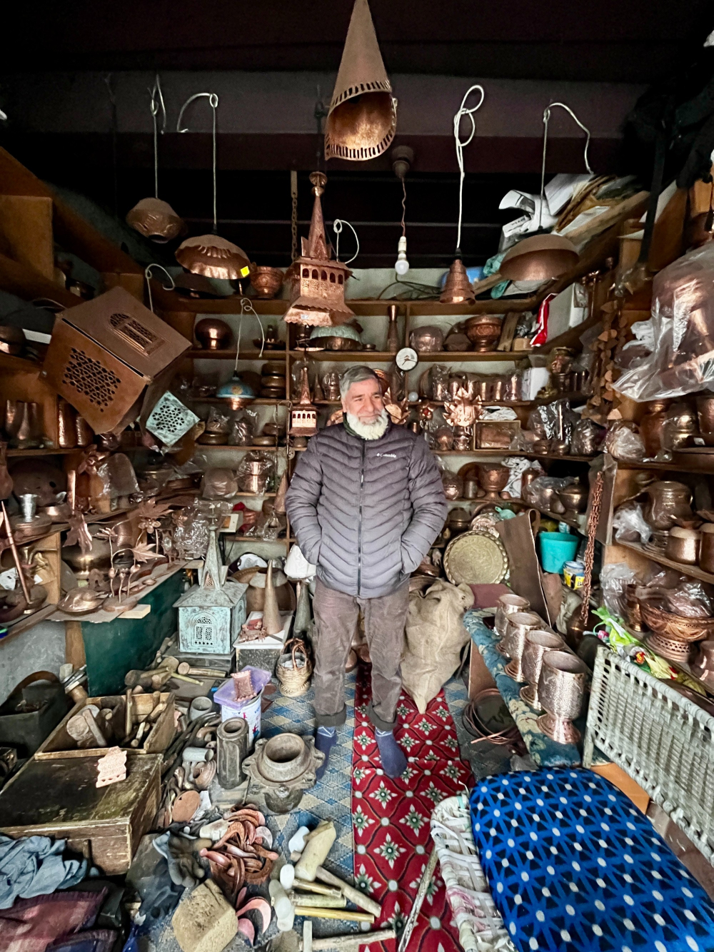A copperware shop displaying handcrafted samovars, trays, and utensils, each adorned with traditional taan kaam engravings. (Picture Credits: Taha Mughal)