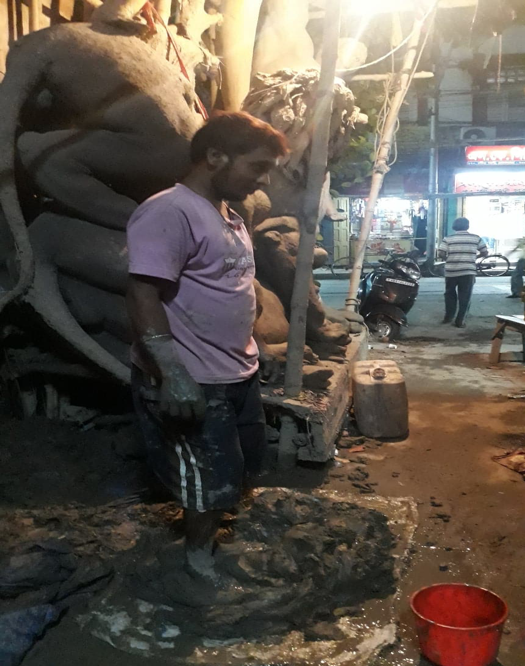 A craftsman stomps on the mud used to make the idol. (Courtesy: Aaheli Sen)