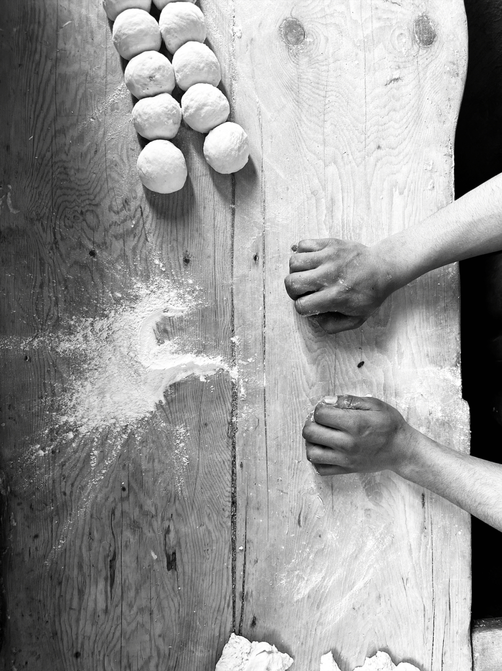 Preparing the dough balls on elevated takhte or wooden board. (Picture Credits: Taha Mughal)