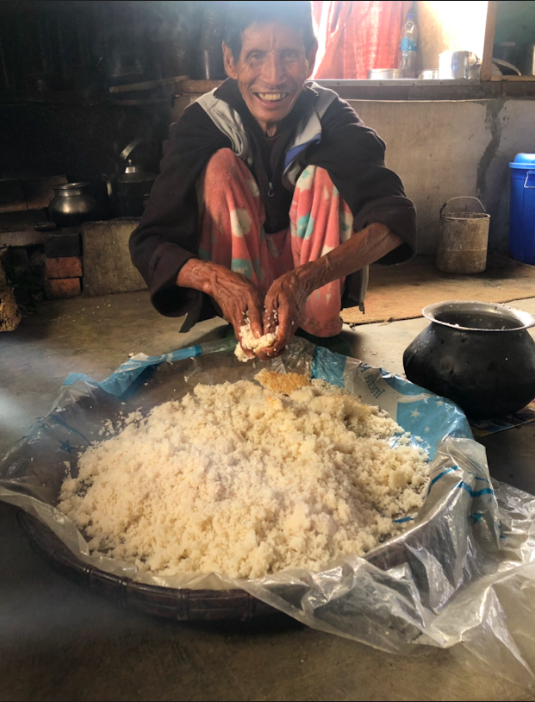 Fig. 1: A resident at a village in Tamenglong makes rice beer. He is mixing fermented rice cake with the rice. Rice was an integral part of the Ruangmei life and rice beer was akin to tea for the people. Rice beer was a drink for every occasion and songs were sung during the process of making it 
