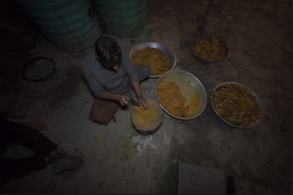 A waza cutting marinated meat with khont (wooden base) and kharu (knife). (Picture Credits: Syed Muneeb Masoodi)