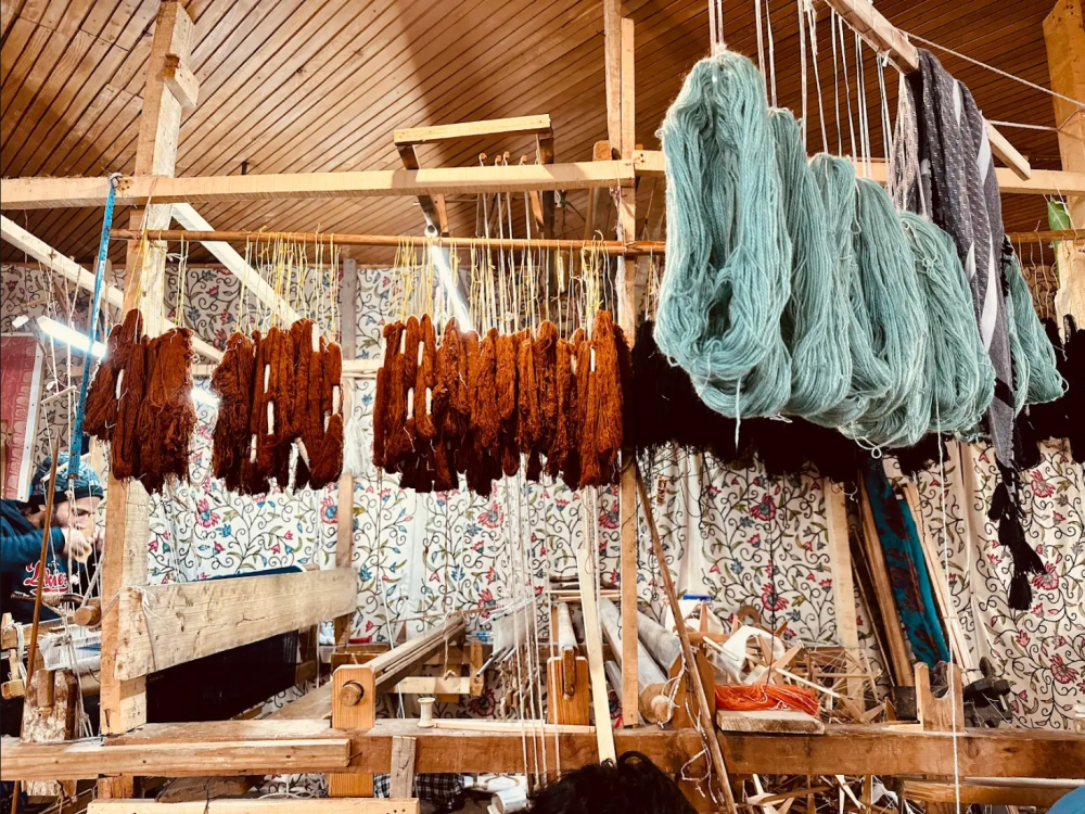 Yarns hanging in a handloom workshop, prepared for weaving. 