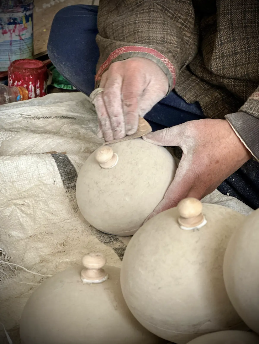 Papier-mâché objects getting ready for painting.