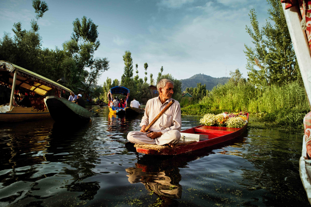 Farmers gather at the floating market with their boats laden with vegetables, flowers and fruits.
