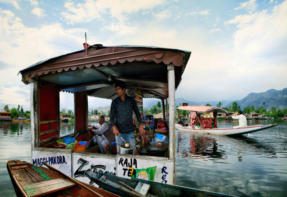 A tea vendor on the Dal Lake in an improvised floating stall. 