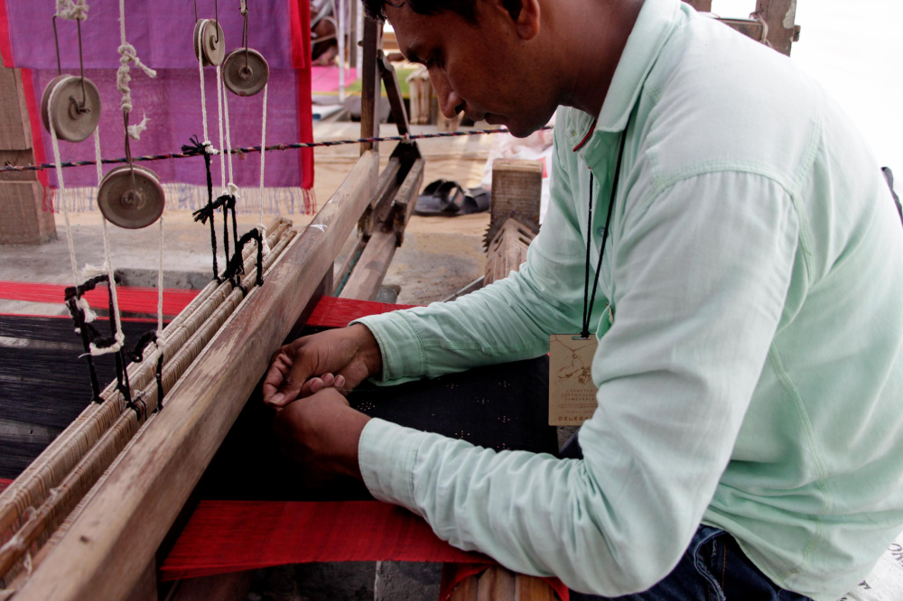 The weave of the thangaliya cloth is a simple plain weave. The dots are created using fine cotton threads. Motifs are woven into the fabric while still on the loom.
