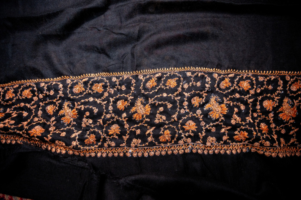 A pashmina shawl adorned with delicate sozni embroidery.