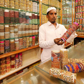 Interior of a bangle shop in Laad Bazaar. Some of the bangle showrooms are very brightly lit like jewellery shops, and the bangles are displayed neatly arranged in glass showcases. Though this is a wholesale market, most shopkeepers also sell loose bangles. Customers are free to mix and match the bangles as per their preferences. 