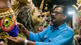 Mintu Pal fixing the costumes on his clay idols prior to delivery (Courtesy: Aaheli Sen)